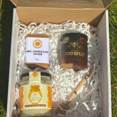 An example image of our Honey Lovers Gift Box with 2 jars of local honey, a soothing honey, lavender and rose soap bar and a honey dipper